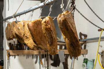 Goriano Sicoli, Italy Fresh proscuitto ham hanging for curing.