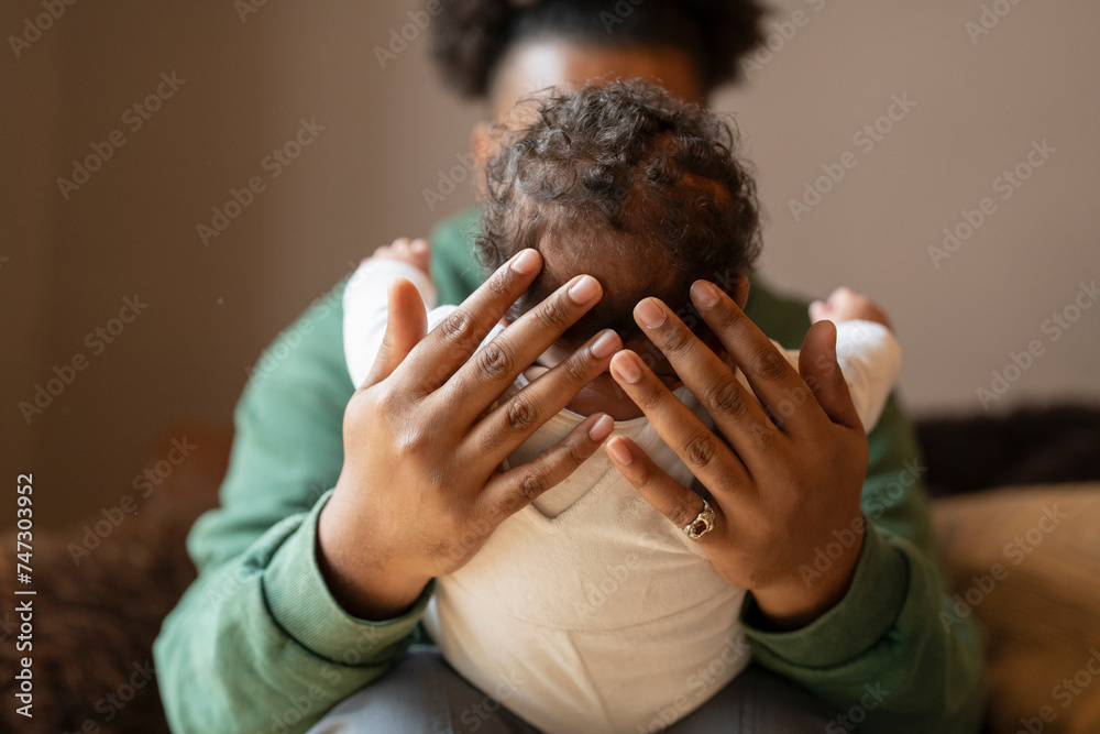 Wall mural Father holding baby daughter at home