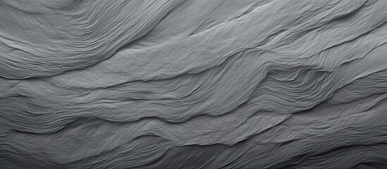 The black and white photo showcases a striking rock formation with intricate layers and textures. The contrast between light and shadow highlights the geological features of the rocks.