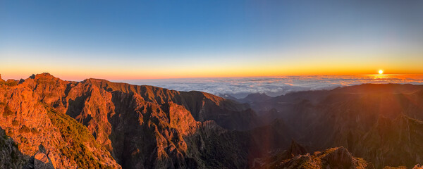Panoramic view of majestic mountain ridges at sunrise seen from top of Pico do Areeiro, Madeira...