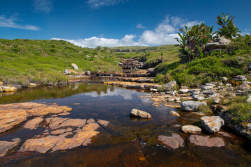 Fototapeta na wymiar The Wild Coast, known also as the Transkei, is a 250 Kilometre long stretch of rugged and unspoiled Coastline that stretches North of East London along sweeping Bays, footprint-free Beaches, lazy Lago