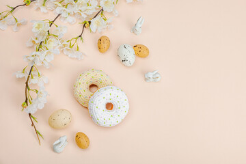 Fototapeta na wymiar Handmade crocheted donuts with blooming cherry branches. Festive Easter, greeting card