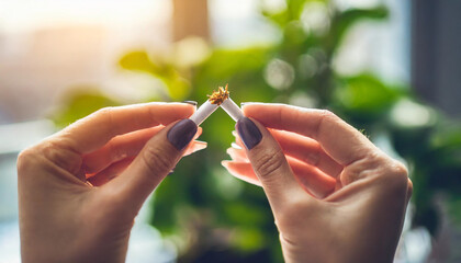 Hands break cigarette, symbolizing quitting smoking