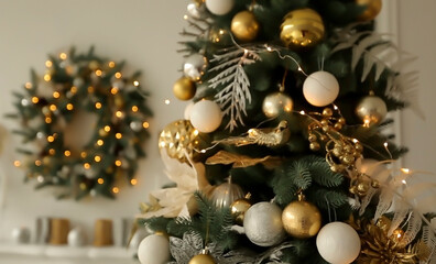 Close up balls on Christmas tree. Bokeh garlands in the background. New Year concept. Decorated Christmas tree on blurred background.