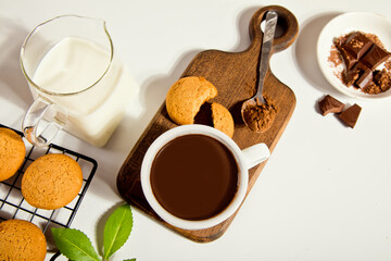 Hot chocolate with chocolate pieces and cookies. Top view.