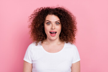 Photo of impressed ecstatic woman with perming coiffure dressed white t-shirt staring at awesome...