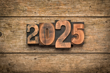 2025, year set with vintage letterpress printing blocks on rustic wooden background - 747332379