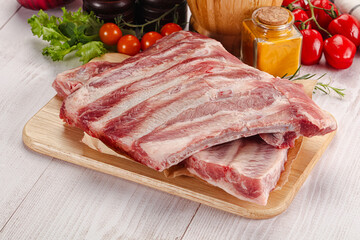 Raw pork ribs over board