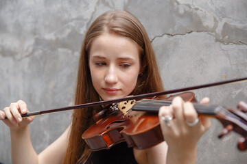 Young woman with white hair and blonde hair playing violin. beautiful musician female performer instrument play music.