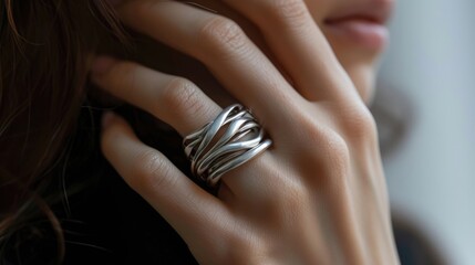 Close-up of hand with unique silver twist ring.