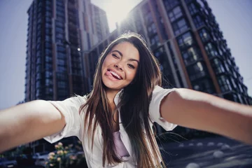 Fotobehang Photo of cute excited person eye wink blink teeth bite tongue out take selfie free time sunny weather city center outdoors © deagreez