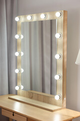 Beautiful mirror with light bulbs in makeup room