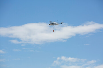 firefighting helicopter hydrating a fire