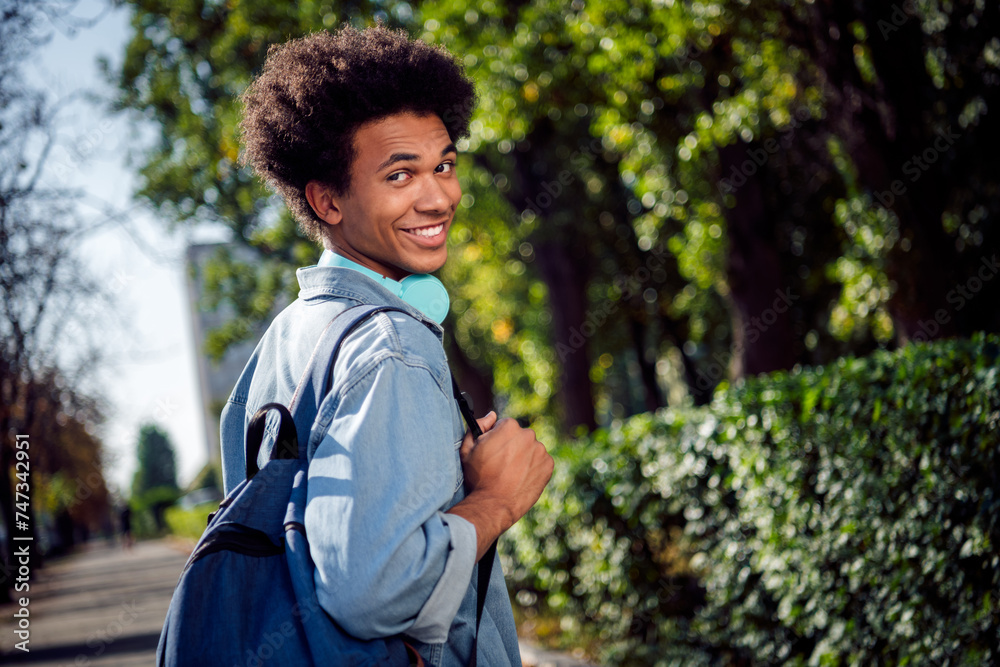 Canvas Prints photo of attractive funny guy wear denim jacket earphones walking college lessons outside urban city