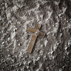 Religious background with wooden cross on ashes