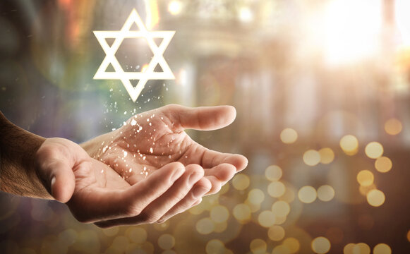 Hands and star floating with glitters and religious background