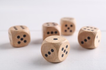 Many game dices on white wooden table, closeup