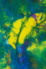 Abstract background of acrylic paint in blue, green and yellow tones.