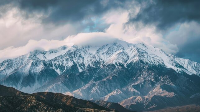 This is a beautiful landscape photograph of snow-capped mountains. The mountains are in the distance and are covered in snow.