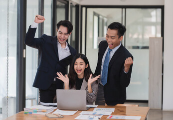 Happy and joyful team of business people celebrating, clepping for an excellent business achievement .