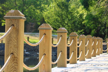 rope railing made of wood. wooden fence
