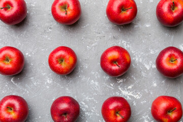 Many red apples on colored background, top view. Autumn pattern with fresh apple above view