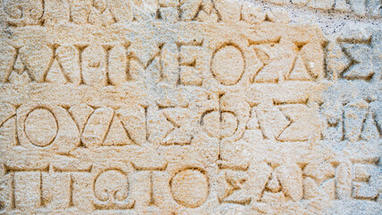 Close-up  background of ancient Greek writings on the ruins of an ancient city