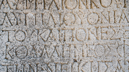 Close-up  background of ancient Greek writings on the ruins of an ancient city