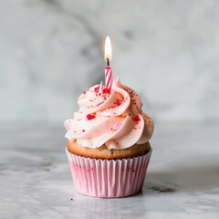 Birthday pink cupcake with butter cream icing isolated on white background. Cup cake with candle - obrazy, fototapety, plakaty