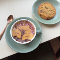 Cup of coffee latte with tree shape. Latte art with cookies.