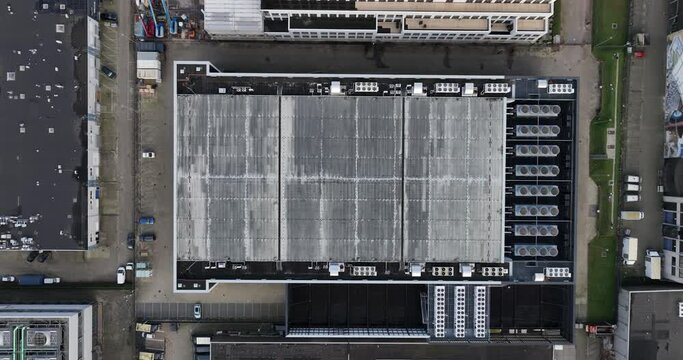Aerial top down drone view on a data center and cooling vans build in the roof.