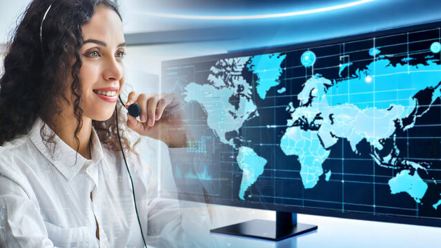 Young friendly operator woman agent with headsets. Beautiful business woman wearing microphone working at office as a telemarketing customer service agent with world map networking connection