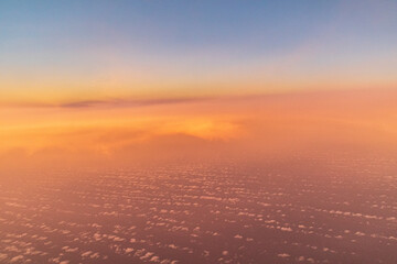 Fototapeta premium Evening cloudscape near the Canary Island of Lanzarote, Spain viewed from a passing aircraft towards sunset.
