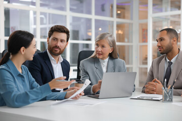 Lawyers working together at table in office