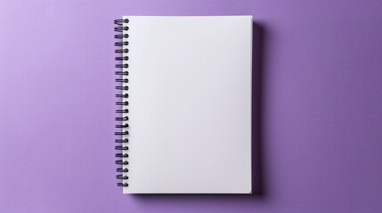 An empty notebook lying flat with a spiral binding visible set against a muted lavender background inviting peaceful journaling