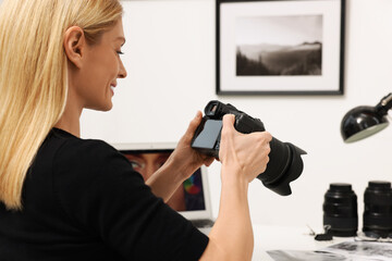 Professional photographer with digital camera indoors, closeup