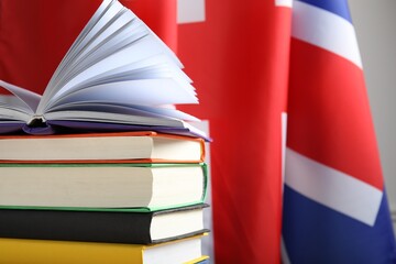 Learning foreign language. Different books against flag of United Kingdom, space for text