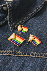 three pins with the LGTBI rainbow flag flag