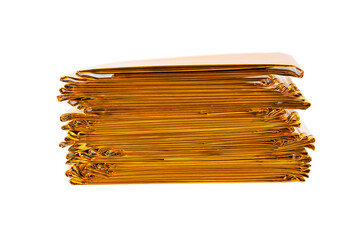Stack of Emergency Rescue Gold Foil Isothermal Blankets. Isolated on a white background.