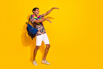 Fototapeta na wymiar Full length body photo of boogie woogie dancing guy in shorts t shirt and hawaii style necklace isolated on yellow color background
