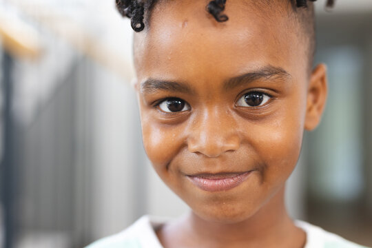 Close-up of a smiling African American boy with short curly hair