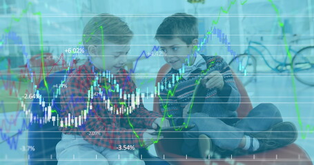 Image of financial data processing over two boys using digital tablets