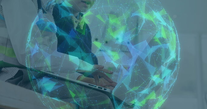 Image of digital globe formed with network of connections over schoolboy using laptop computer - Powered by Adobe