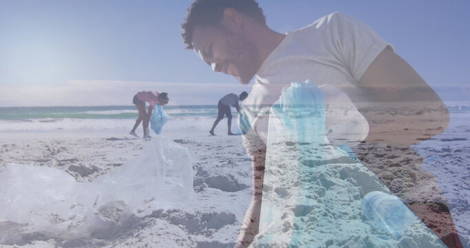 Image of african american man over african american couple segregating waste at beach - Powered by Adobe
