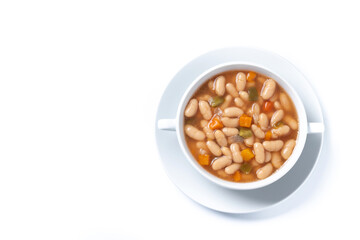 white beans soup with vegetables in white bowl isolated on white background. Top view. Copy space