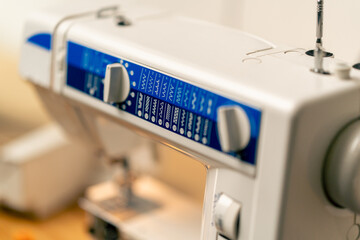 close-up in a sewing workshop on machine showing possible stitch patterns