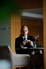 African american businessman holding coffee cup in business center