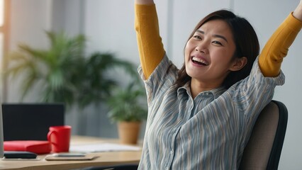 Asian woman very happy and excited doing winner gesture with arms raised