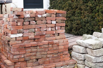 The piles of bricks and stones will be used in a construction project.