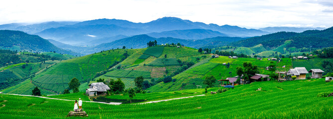 couple in landscape Terraced green rice paddy field at sunset, Pa Pong Pieng, Chiang mai, Thailand